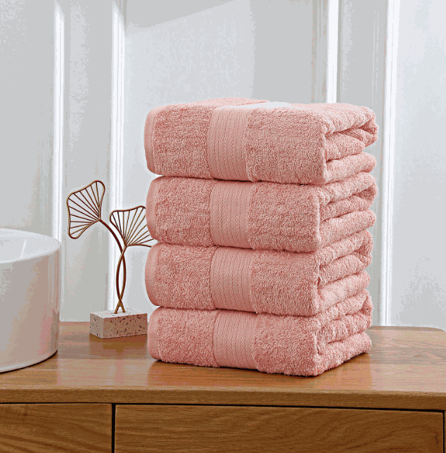 pink towels stacked on wooden shelf