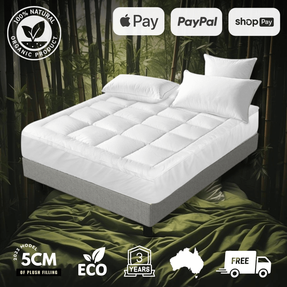 Luxury bamboo mattress topper with a plush, quilted design on a bed, offering enhanced comfort and support. Breathable, hypoallergenic, and ultra-soft for a restful sleep experience. Ideal for improving mattress durability and coziness