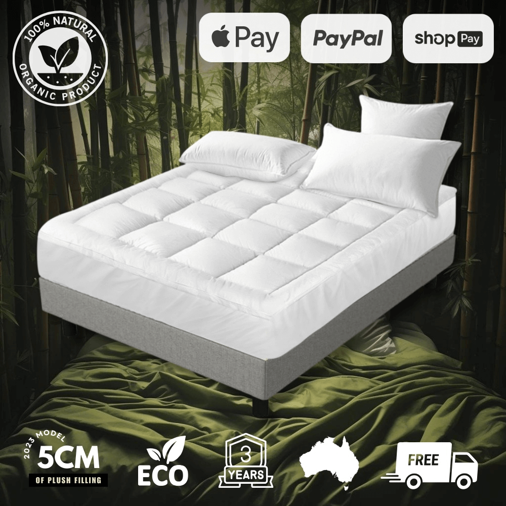 Premium bamboo mattress topper on a bed, featuring a plush, quilted design for extra comfort. Hypoallergenic, breathable, and ultra-soft for a luxurious sleep experience. Ideal for enhancing mattress support and protection.