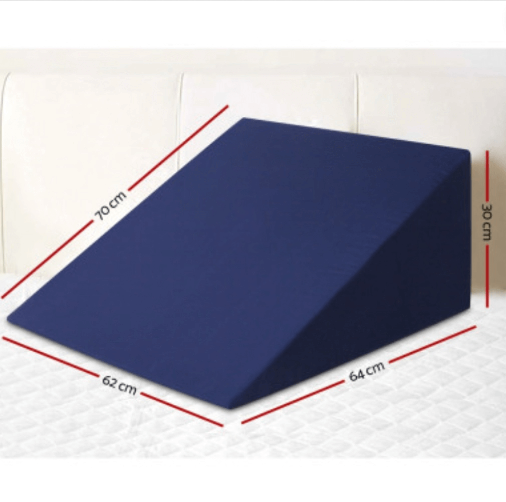 Navy blue wedge pillow for back and leg support.