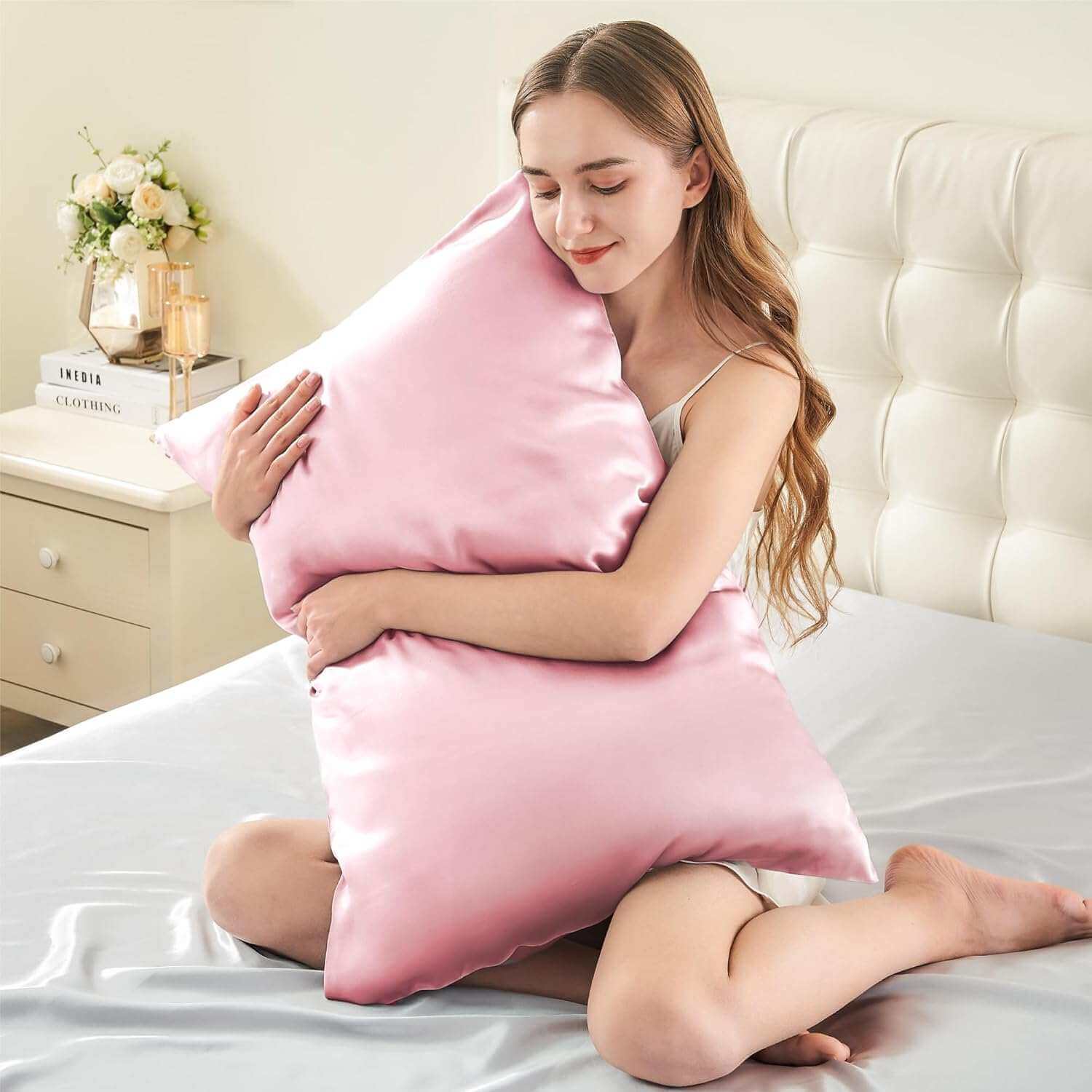 Woman embracing a luxurious pink silk pillow case, highlighting its ultra-soft and smooth texture. This silk pillow case is designed for ultimate comfort, hair protection, and a breathable, skin-friendly sleep experience.