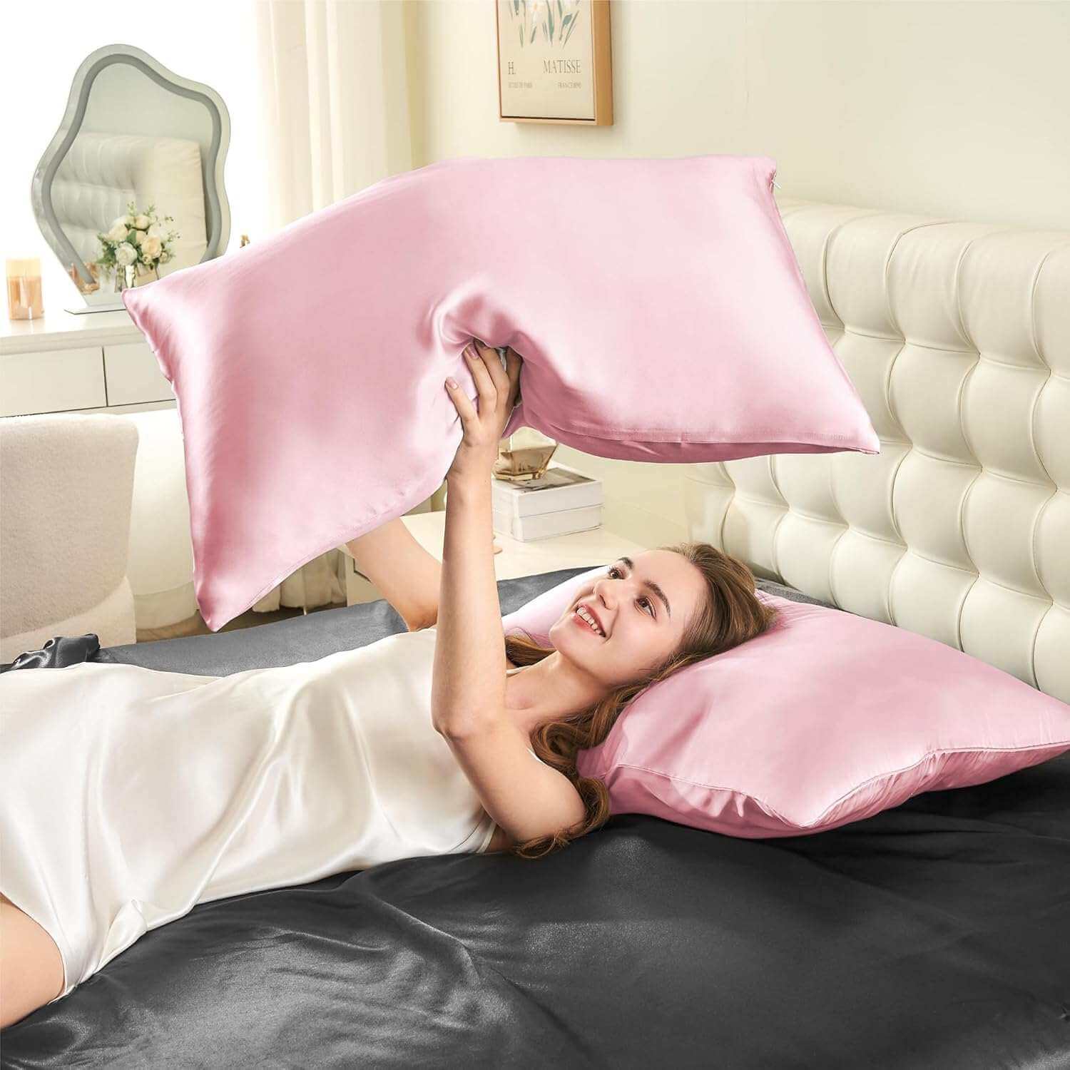 Woman joyfully tossing a pink silk pillow case in the air, highlighting its smooth, soft, and luxurious texture. This silk pillow case is designed for superior comfort, hair protection, and a breathable, skin-friendly sleep experience