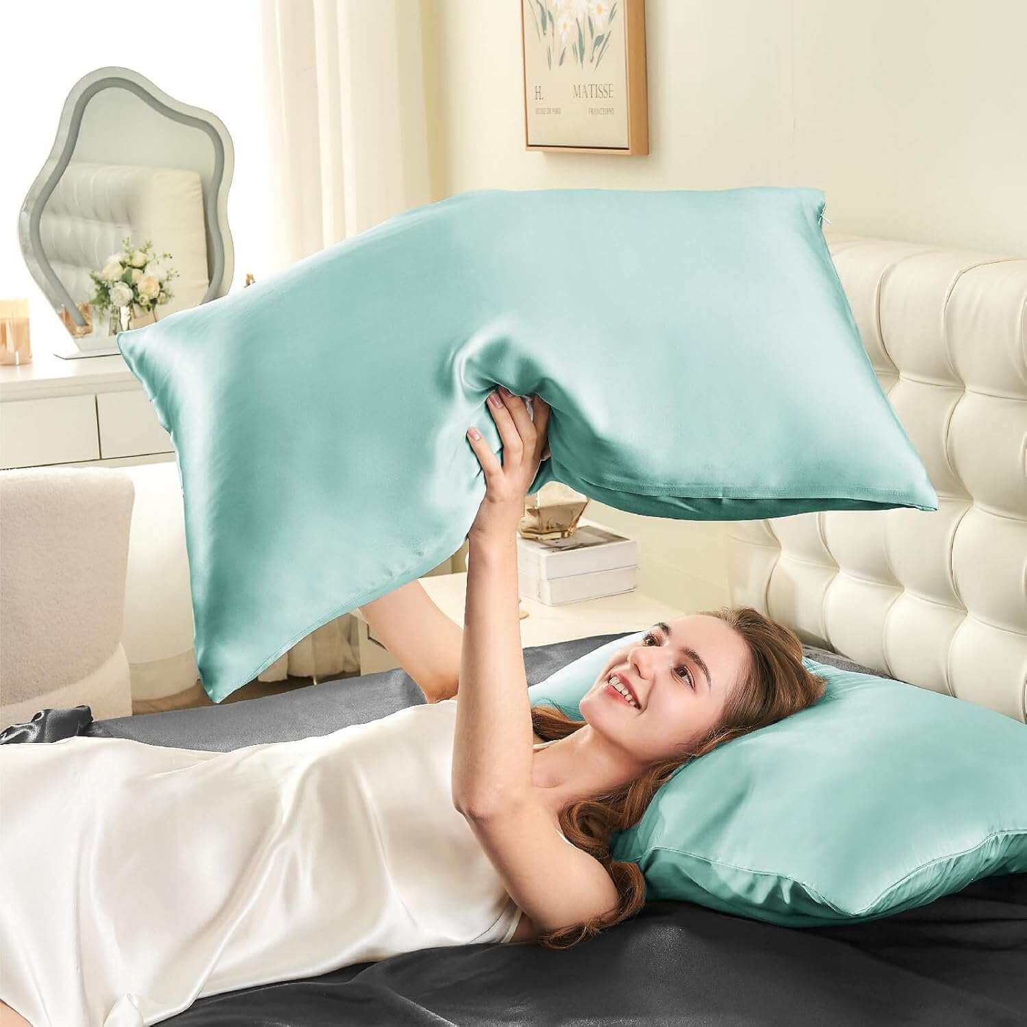 Woman joyfully tossing a light blue silk pillow case in the air, highlighting its smooth, soft, and luxurious texture. This silk pillow case is designed for superior comfort, hair protection, and a breathable, skin-friendly sleep experience