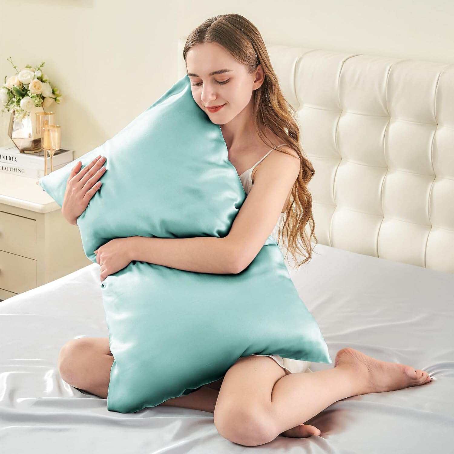Woman embracing a luxurious light blue silk pillow case, highlighting its ultra-soft and smooth texture. This silk pillow case is designed for ultimate comfort, hair protection, and a breathable, skin-friendly sleep experience.