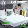 Bamboo mattress protector on a bed for waterproof and breathable protection.