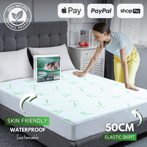 Bamboo mattress protector on a bed for waterproof and breathable protection.