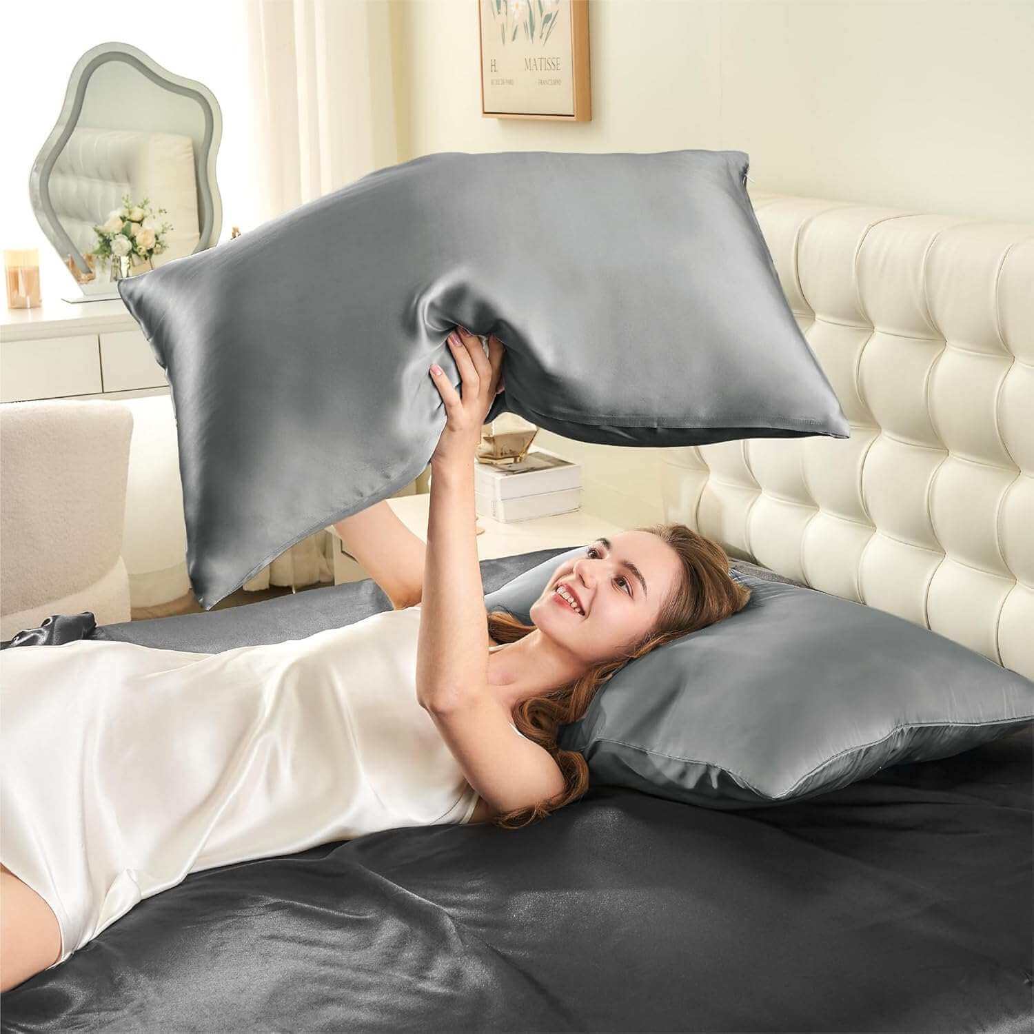 Woman joyfully tossing a silver silk pillow case in the air, highlighting its smooth, soft, and luxurious texture. This silk pillow case is designed for superior comfort, hair protection, and a breathable, skin-friendly sleep experience.
