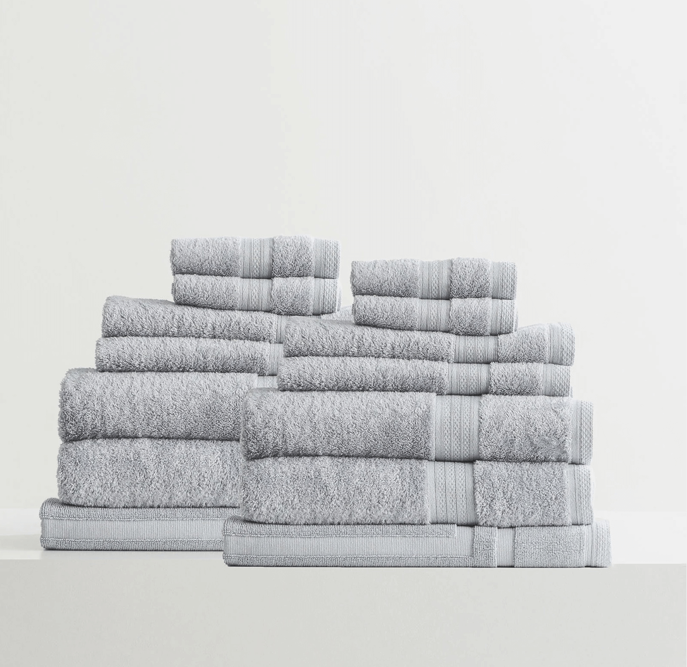 Adorearth™ organic bamboo towels in grey neatly stacked in a set.