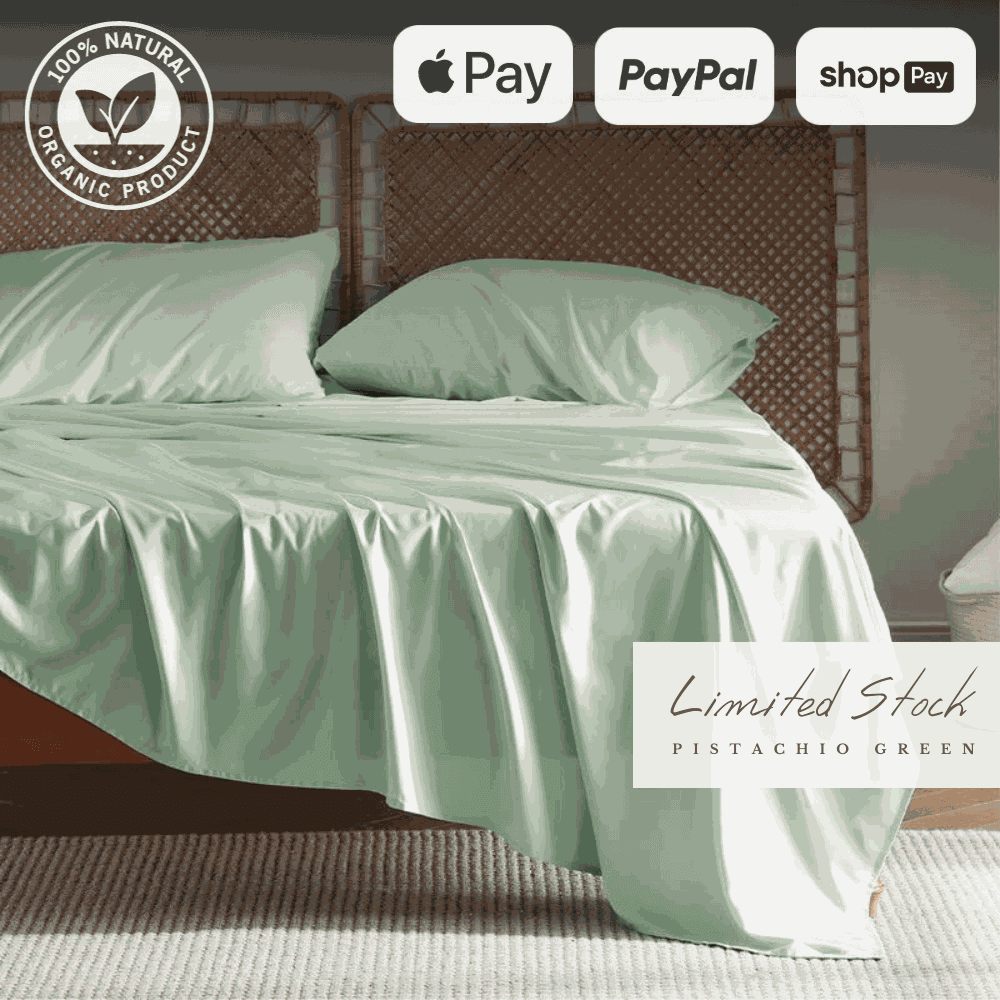 Elegant and breathable bamboo bed sheets in a soft green color, draped over a bed for a luxurious sleep experience. These bamboo sheets are moisture-wicking, hypoallergenic, and ultra-soft, providing ultimate comfort and durability.