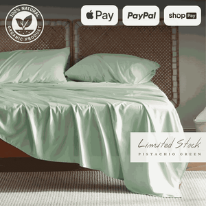 Elegant and breathable bamboo bed sheets in a soft green color, draped over a bed for a luxurious sleep experience. These bamboo sheets are moisture-wicking, hypoallergenic, and ultra-soft, providing ultimate comfort and durability.