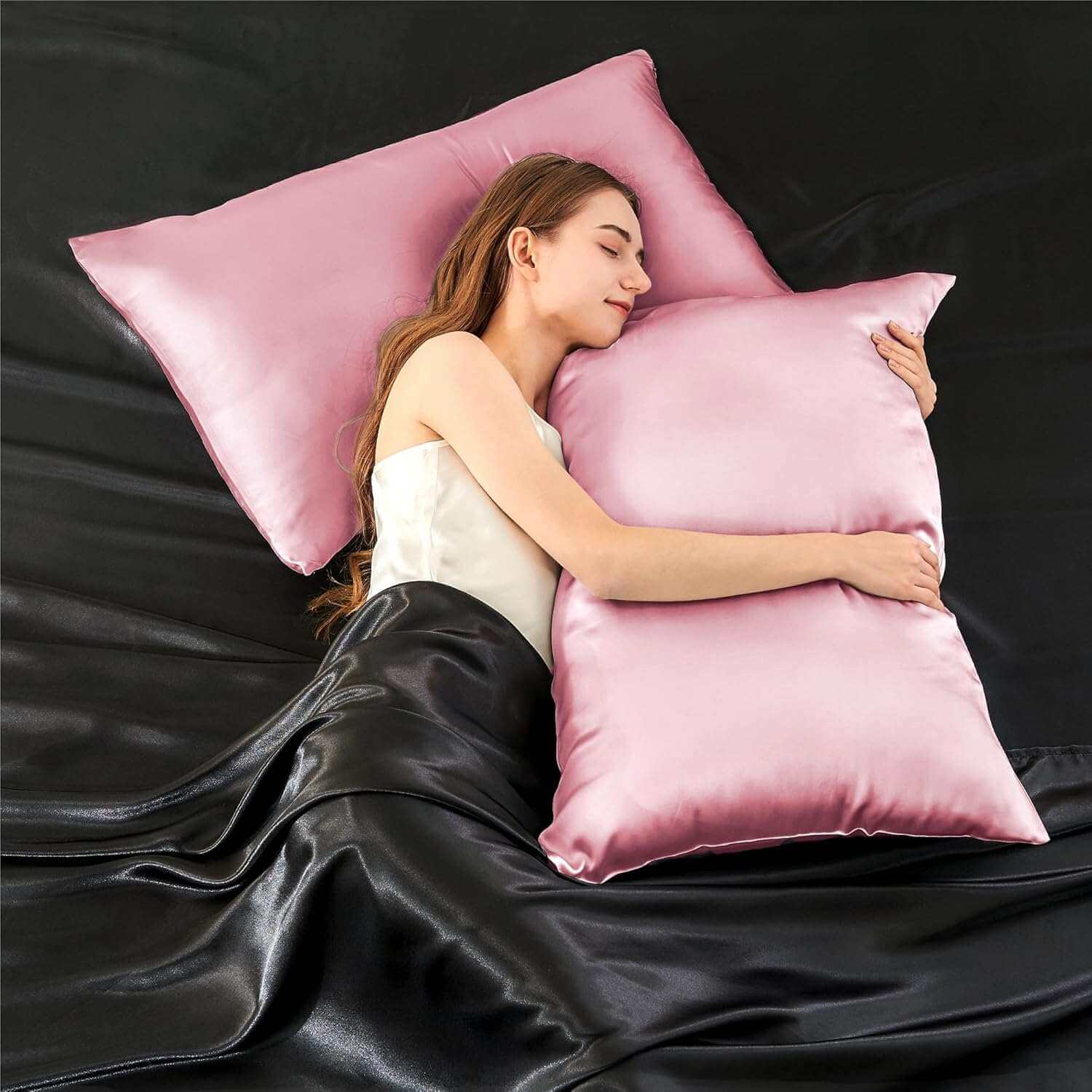Woman relaxing on a bed with a luxurious pink silk pillow case, highlighting its ultra-soft and smooth texture. This silk pillow case is designed for ultimate comfort, skin-friendly benefits, and hair protection for a restful sleep.