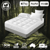 Bamboo mattress protector on a bed for soft, waterproof, and eco-friendly protection.