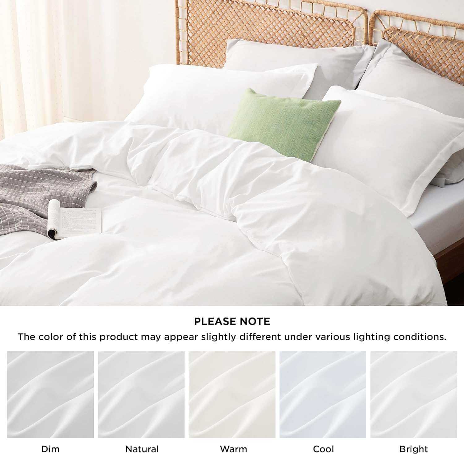 A neatly made bed with white sheets and pillows, featuring a light green pillow and a grey blanket. A note at the bottom states, 'PLEASE NOTE: The color of this product may appear slightly different under various lighting conditions,' followed by swatches labeled Dim, Natural, Warm, Cool, and Bright to demonstrate the color variations